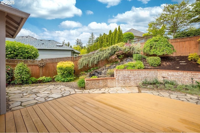 wooden terrace featuring a fenced backyard