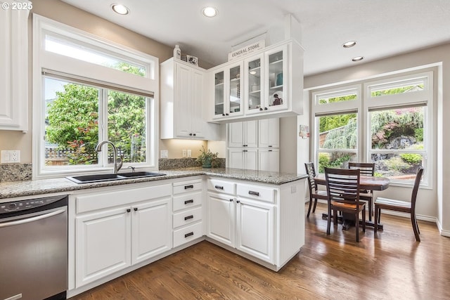 kitchen featuring glass insert cabinets, dark wood-type flooring, white cabinetry, a sink, and dishwasher