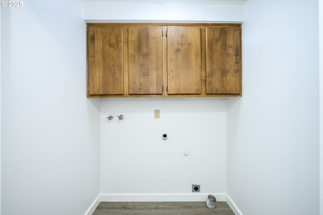 washroom featuring cabinet space, baseboards, wood finished floors, hookup for an electric dryer, and washer hookup