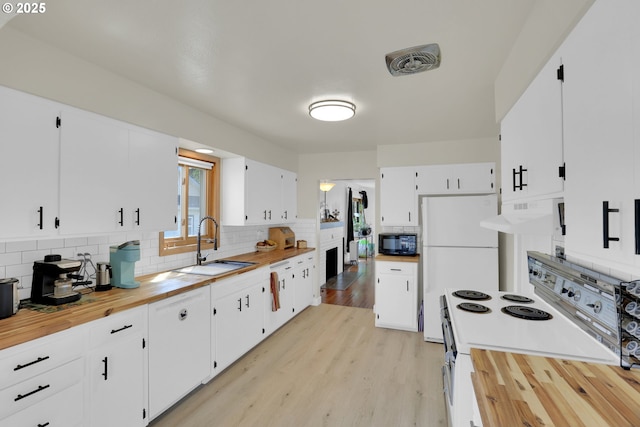 8011 SE Lambert St, Portland, OR 97206 - kitchen featuring a sink, backsplash, under cabinet range hood, and white appliances