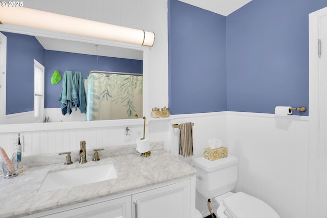 8011 SE Lambert St, Portland, OR 97206 - bathroom featuring toilet, wainscoting, curtained shower, and vanity
