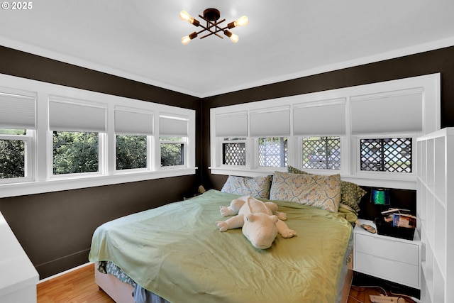 8011 SE Lambert St, Portland, OR 97206 - bedroom with wood finished floors, a chandelier, and multiple windows
