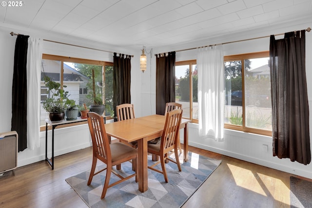 8011 SE Lambert St, Portland, OR 97206 - dining area featuring wood finished floors and a healthy amount of sunlight