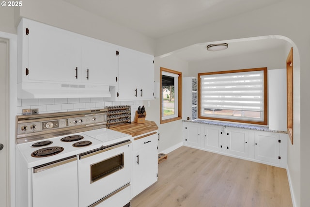 8011 SE Lambert St, Portland, OR 97206 - kitchen with white cabinets, white range with electric cooktop, light wood-style flooring, decorative backsplash, and under cabinet range hood