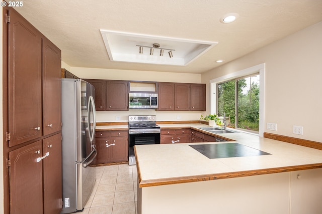 1193 Cedar Pl, Creswell, OR 97426 - kitchen featuring stainless steel appliances, a peninsula, light tile patterned flooring, light countertops, and recessed lighting