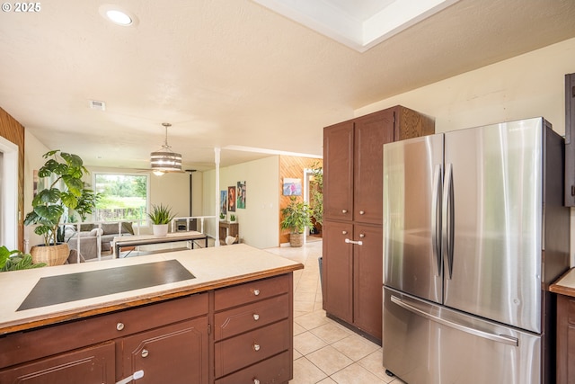 1193 Cedar Pl, Creswell, OR 97426 - kitchen with freestanding refrigerator, light tile patterned flooring, open floor plan, light countertops, and decorative light fixtures