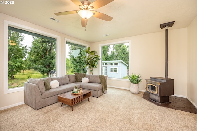 1193 Cedar Pl, Creswell, OR 97426 - carpeted living area with a wood stove, plenty of natural light, and ceiling fan