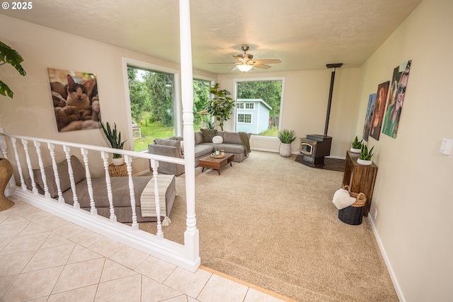 1193 Cedar Pl, Creswell, OR 97426 - carpeted living room with a wood stove, ceiling fan, and tile patterned flooring