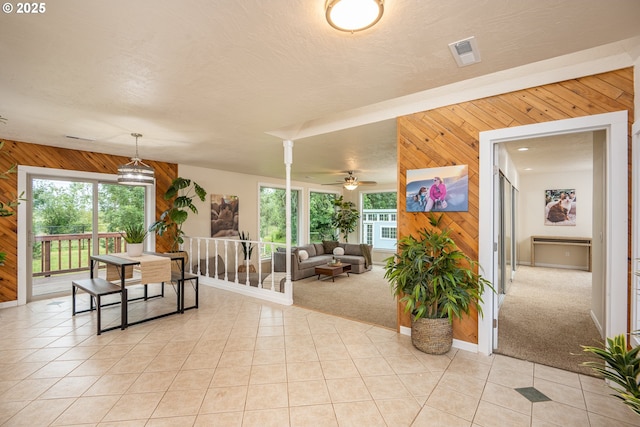 1193 Cedar Pl, Creswell, OR 97426 - dining space featuring wooden walls, light tile patterned floors, ceiling fan, and light carpet