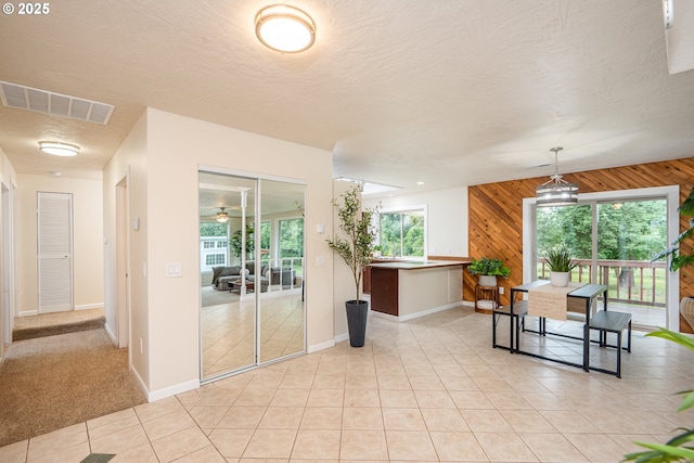 1193 Cedar Pl, Creswell, OR 97426 - dining space with wooden walls, light tile patterned flooring, ceiling fan, and a textured ceiling