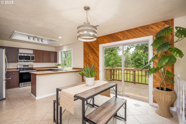 1193 Cedar Pl, Creswell, OR 97426 - dining area with wood walls, light tile patterned flooring, a chandelier, a raised ceiling, and recessed lighting