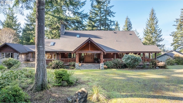 rear view of house featuring a shingled roof, log siding, covered porch, a chimney, and a yard