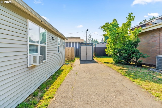1483 5th St, Springfield, OR 97477 - view of yard with a shed, cooling unit, and asphalt driveway