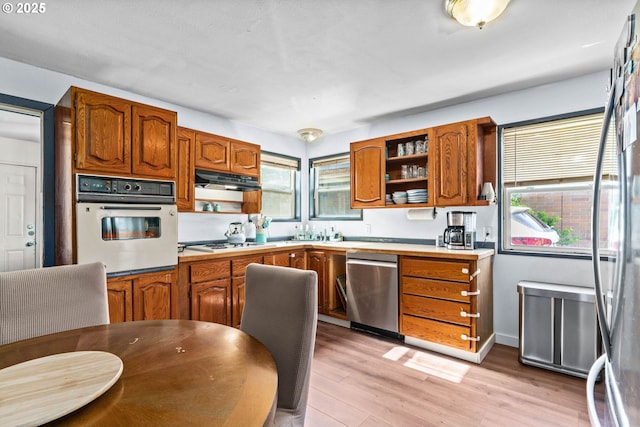 1483 5th St, Springfield, OR 97477 - kitchen featuring white appliances, open shelves, brown cabinets, light wood-type flooring, and light countertops