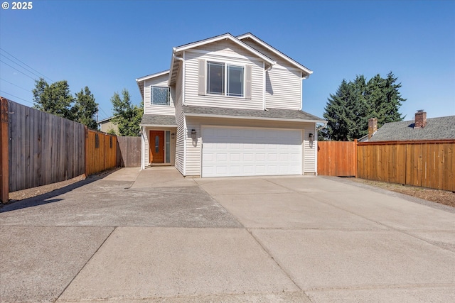 traditional-style house featuring a garage and concrete driveway