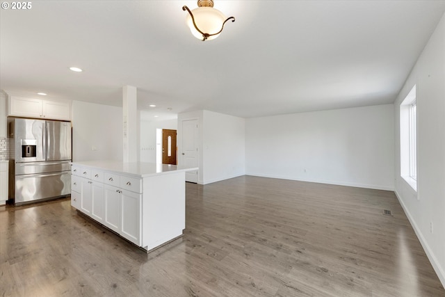 unfurnished living room featuring wood finished floors and recessed lighting