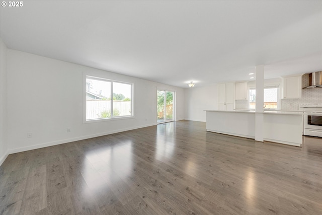 unfurnished living room featuring wood finished floors