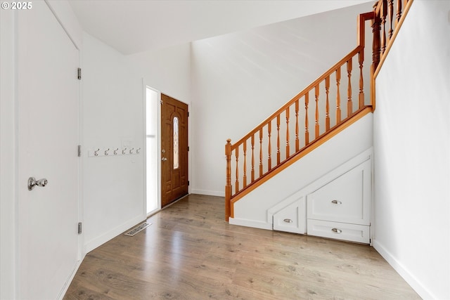 entrance foyer with light wood finished floors and stairway