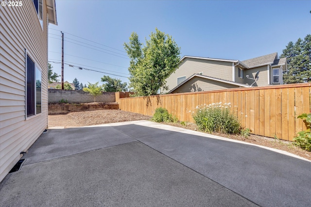 fenced backyard with a patio area