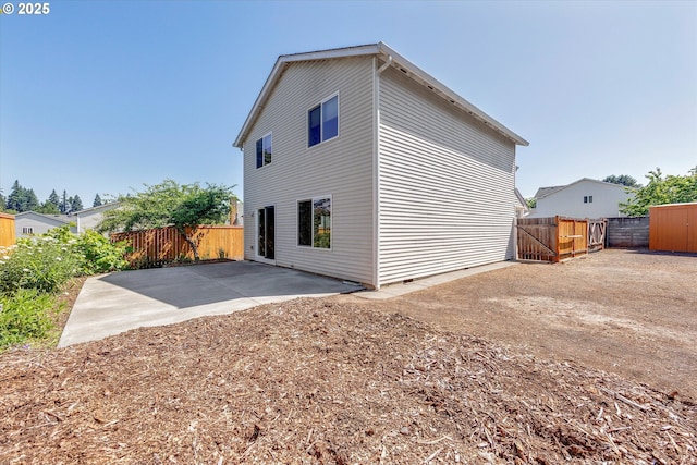 back of house featuring a patio and a fenced backyard