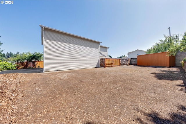 rear view of property featuring a gate