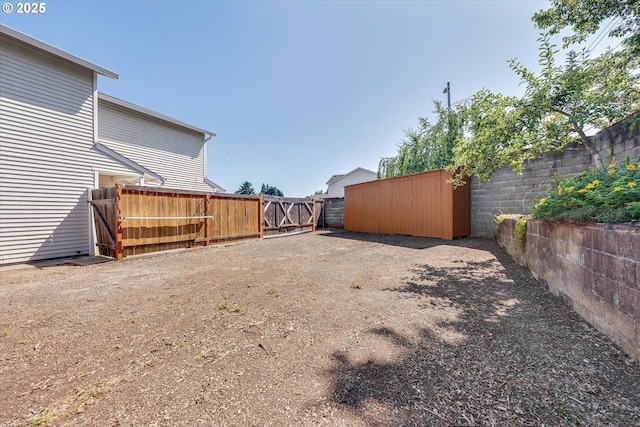 fenced backyard with a gate