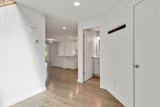 corridor featuring recessed lighting and light wood-style flooring