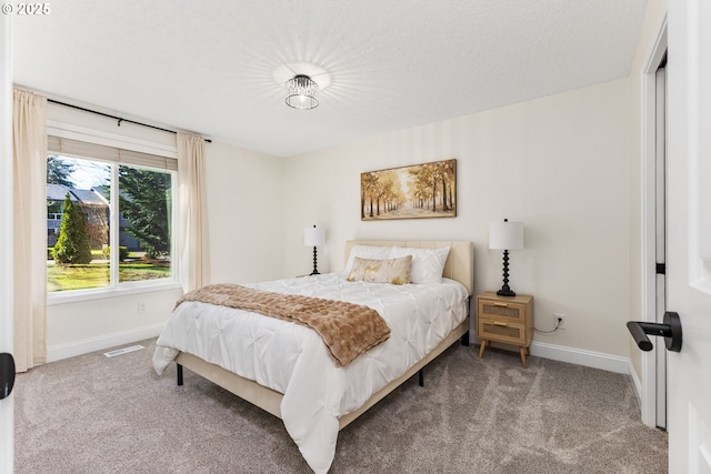 carpeted bedroom featuring baseboards and visible vents