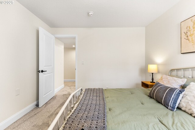 carpeted bedroom with baseboards