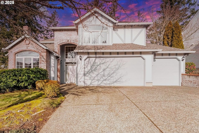 tudor house featuring a garage