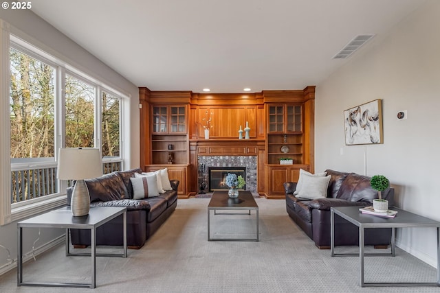 living room featuring a fireplace and light colored carpet