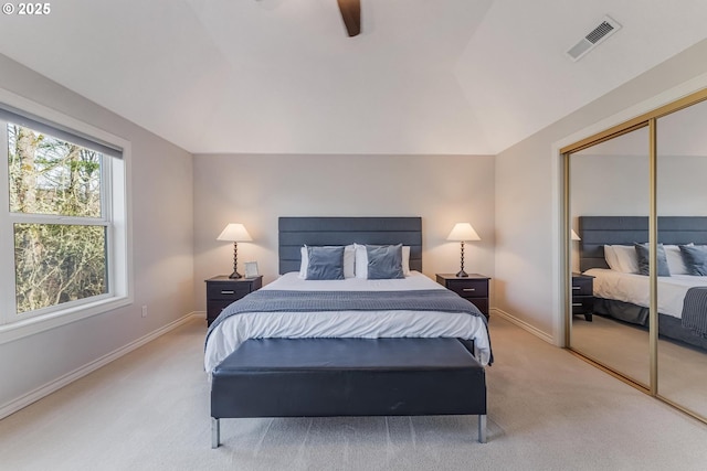 bedroom with light carpet, a closet, and ceiling fan