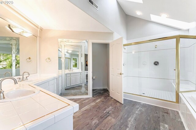 bathroom featuring vanity, a shower with shower door, and hardwood / wood-style floors