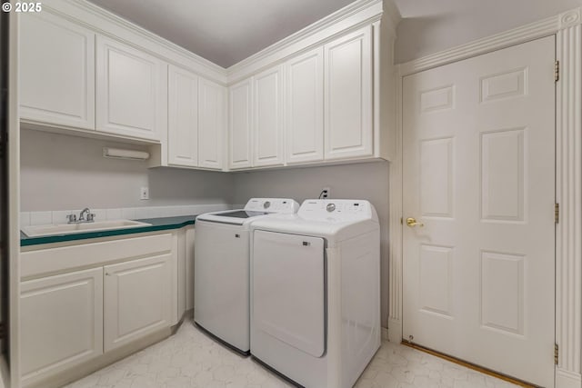 laundry area with cabinets, independent washer and dryer, and sink