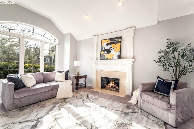 living room featuring lofted ceiling and a fireplace