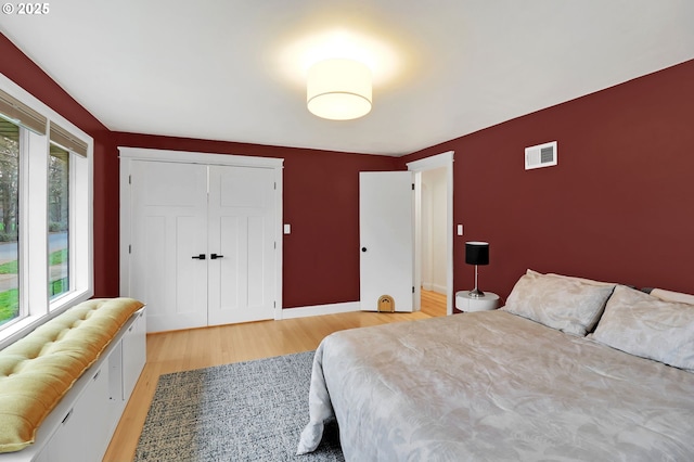 bedroom featuring light wood-type flooring and a closet