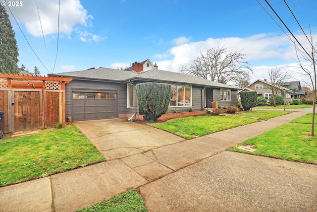 view of front of property featuring a garage and a front yard