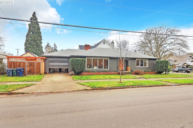 ranch-style house with a garage and a front yard