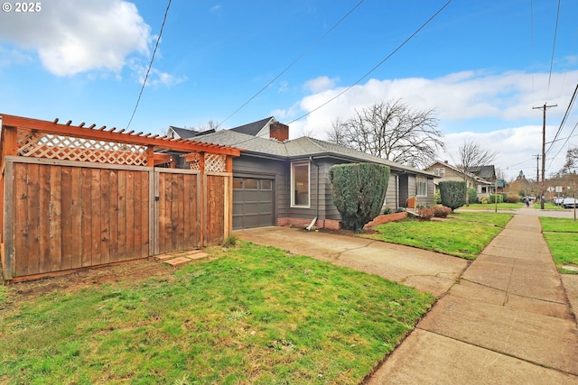 view of front of house with a front yard and a garage