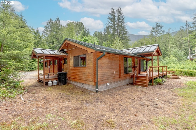 22190 E Lolo Pass Rd, Rhododendron, OR 97049 - view of side of property with metal roof, a deck, a standing seam roof, crawl space, and a view of trees