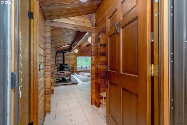 22190 E Lolo Pass Rd, Rhododendron, OR 97049 - entrance foyer with a wood stove, wood ceiling, log walls, and light tile patterned floors