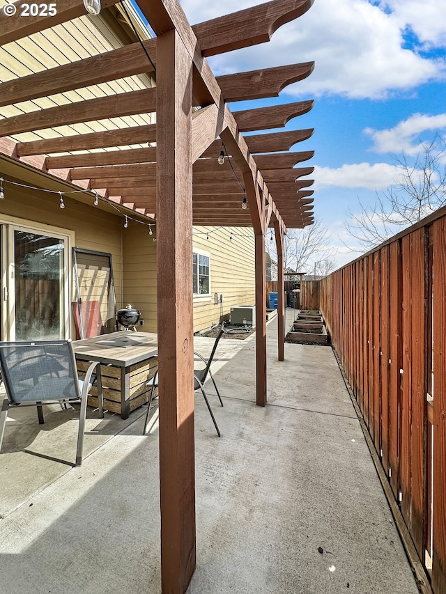 view of patio / terrace with a pergola and fence