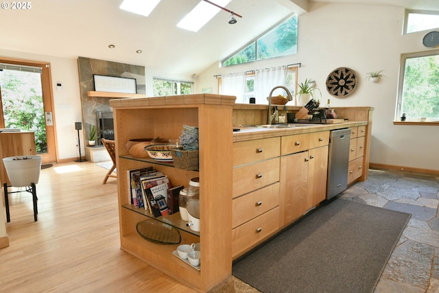 8302 SW 65th Ave, Portland, OR 97219 - kitchen featuring stainless steel dishwasher, a sink, vaulted ceiling, tile counters, and baseboards