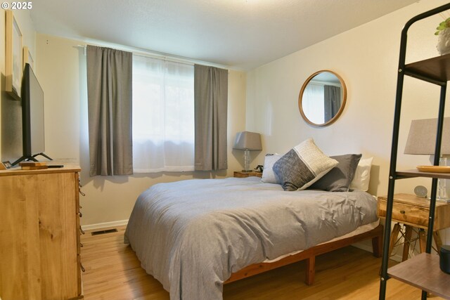 8302 SW 65th Ave, Portland, OR 97219 - bedroom featuring light wood-style flooring and baseboards