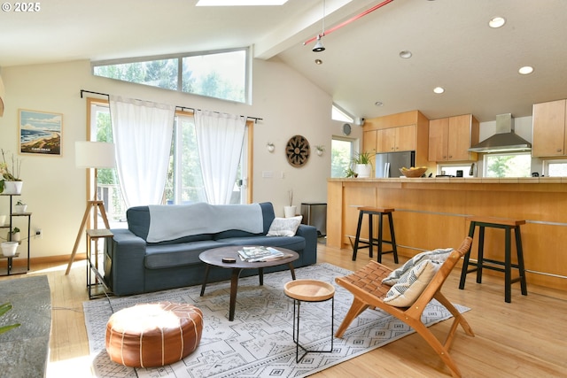8302 SW 65th Ave, Portland, OR 97219 - living room featuring light wood-style floors, beam ceiling, recessed lighting, high vaulted ceiling, and baseboards