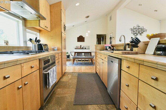 8302 SW 65th Ave, Portland, OR 97219 - kitchen featuring appliances with stainless steel finishes, lofted ceiling, ventilation hood, tile countertops, and a sink