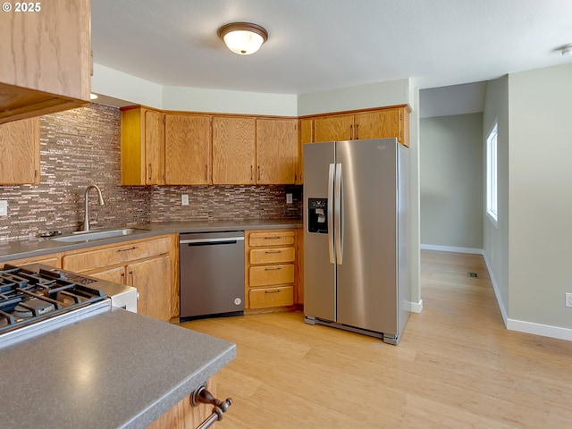 5367 NW 180th Pl, Portland, OR 97229 - kitchen featuring stainless steel appliances, tasteful backsplash, and light wood-type flooring