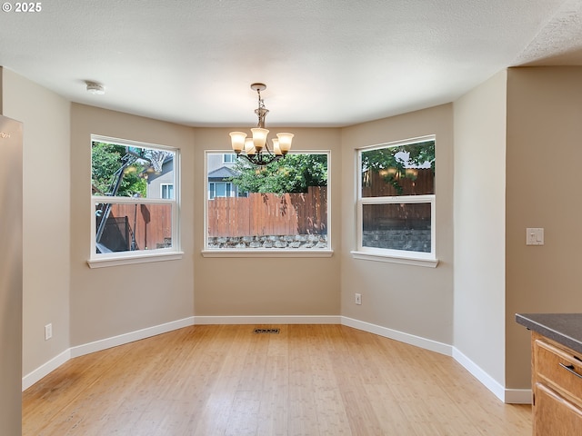 5367 NW 180th Pl, Portland, OR 97229 - unfurnished dining area featuring a chandelier and light wood-style flooring