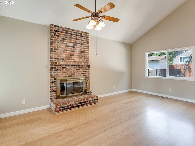 5367 NW 180th Pl, Portland, OR 97229 - unfurnished living room with wood finished floors, a ceiling fan, a fireplace, and high vaulted ceiling