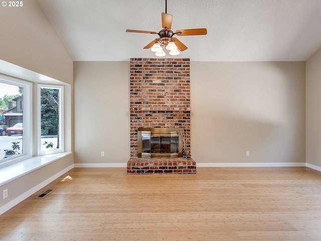 5367 NW 180th Pl, Portland, OR 97229 - unfurnished living room with vaulted ceiling, wood finished floors, a ceiling fan, and a fireplace